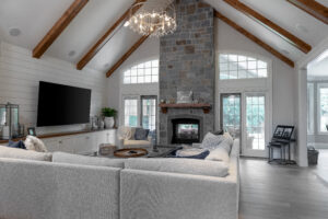 Elegant living room featuring a striking grey stone fireplace and wooden accents
