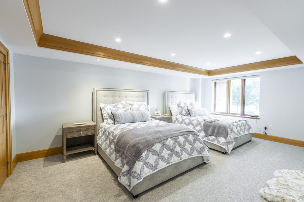 Renovated bedroom featuring soft white walls and light wooden trim, showcasing R.E. McNamara Inc.'s residential renovation expertise.