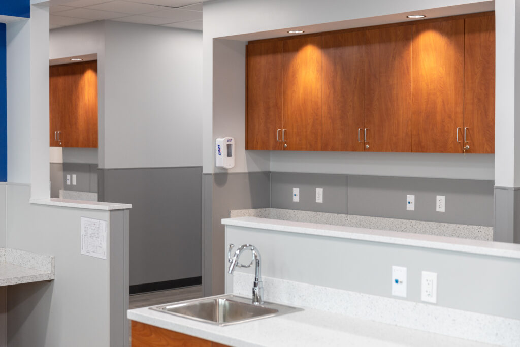 Newly renovated Planned Parenthood office, featuring light custom cabinetry and white counters