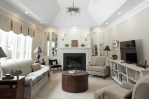 White custom woodwork surrounding a fireplace in a cozy residential living room