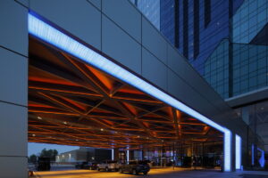 Exterior view of a renovated covered entryway at Seneca Niagara Casino, showcasing a sleek modern design and R.E. McNamara Inc.'s expertise in commercial renovations.