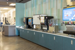 Updated Daemen College Cafe featuring decorative wooden service counters, food preparation areas, and self-service facilities.