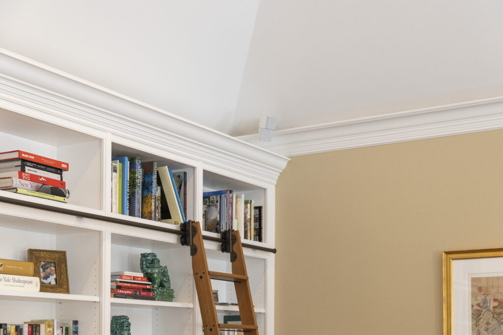 A sophisticated residential renovation features a tailored bookcase wall with white cabinets, showcasing R.E. McNamara Inc.'s excellence in general contracting services.