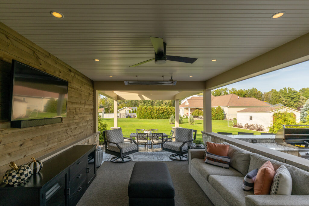 A beautifully designed outdoor covered patio by R.E. McNamara Inc. The warm, inviting atmosphere is perfect for entertaining guests for any residential renovation project.
